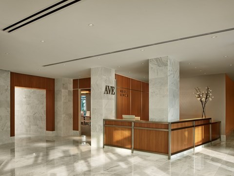 A reception area with a wooden desk and a sign that reads "Avenue.".
