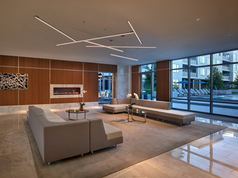 A modern living room with a fireplace and a large window.
