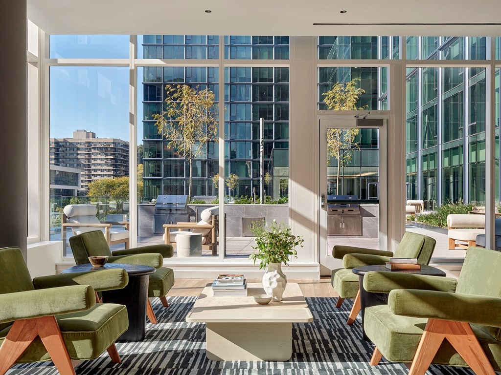 A modern living room with green chairs and a coffee table.