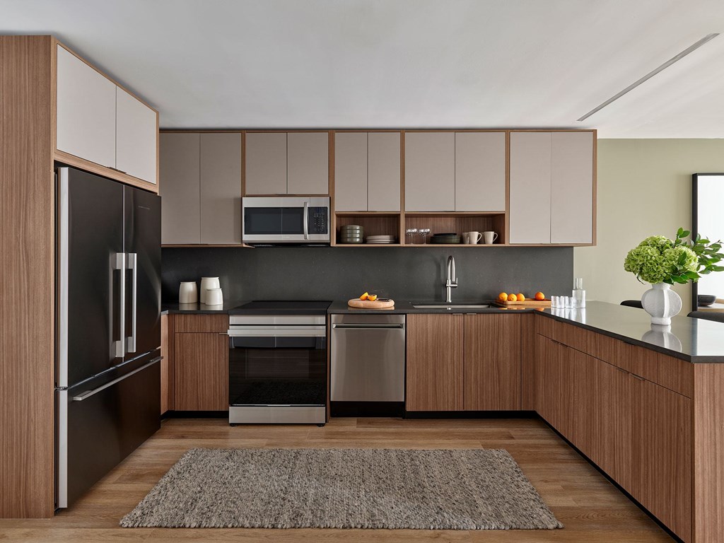 A modern kitchen with wooden cabinets and stainless steel appliances.