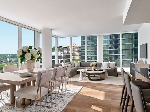 A modern dining room with a large table and chairs.