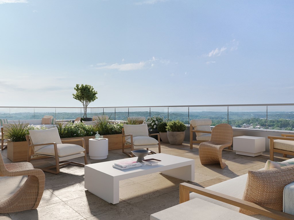 A patio with white furniture and a table with a book on it.