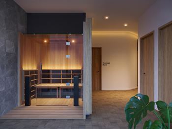 A room with a wooden bench and a door.
