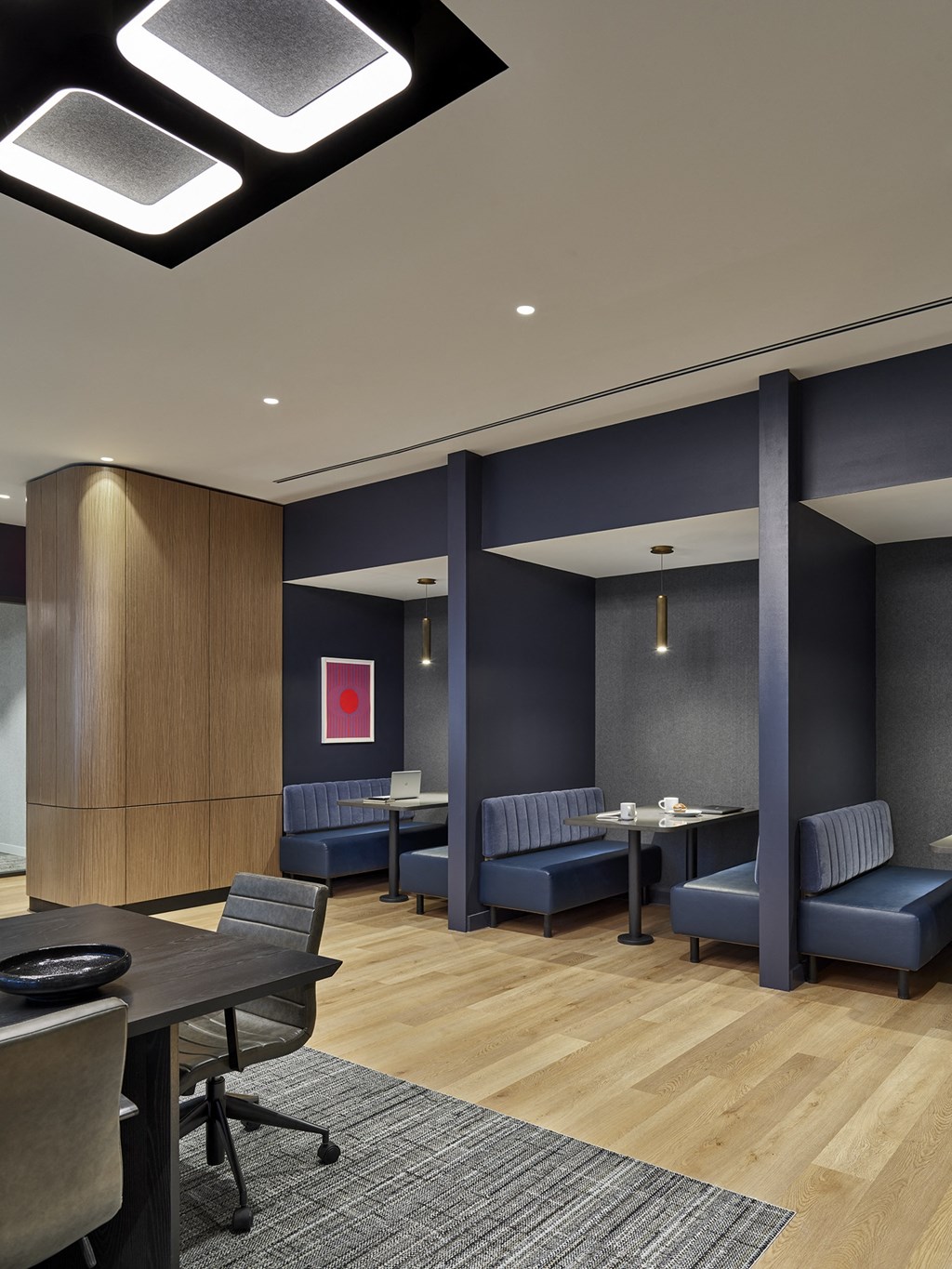 A conference room with a long table and chairs.