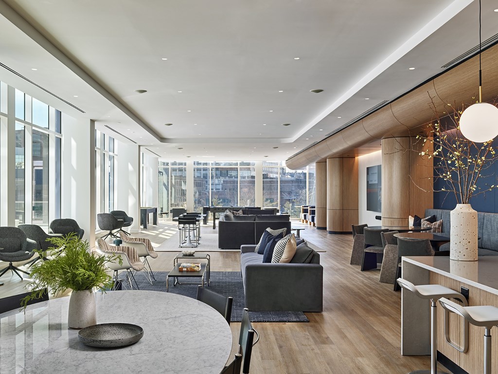 A modern living room with a large table and chairs.