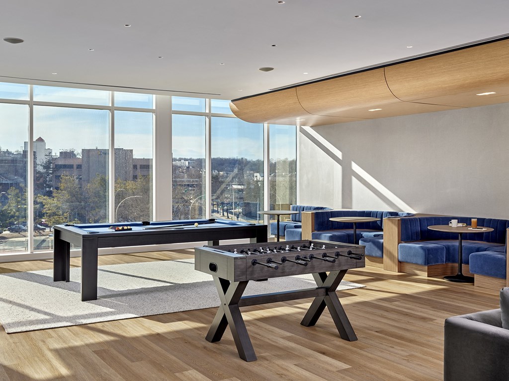 A pool table in a room with a view of the city.