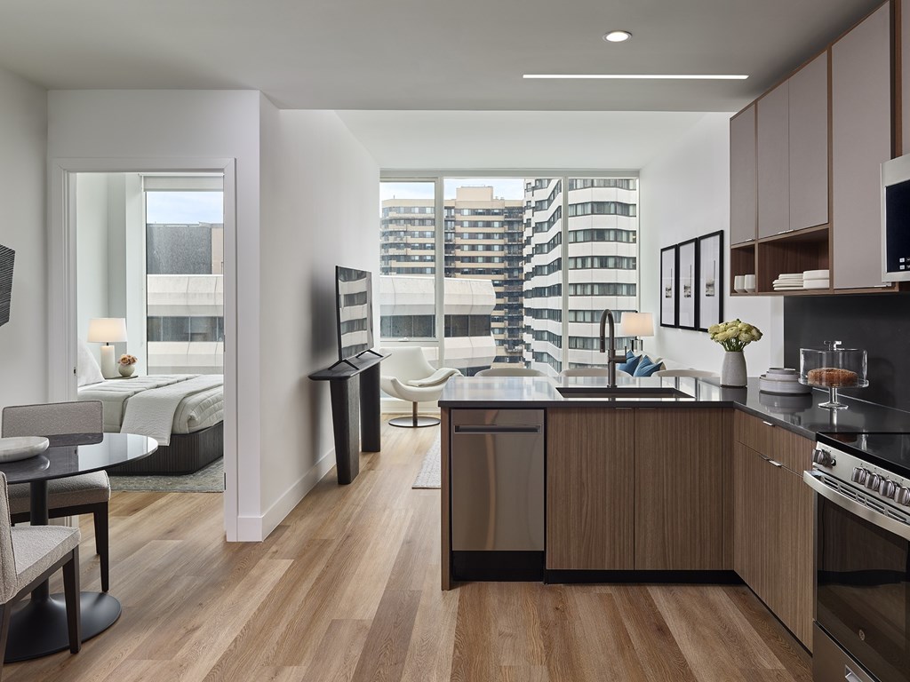 A modern kitchen with wooden floors and furniture.