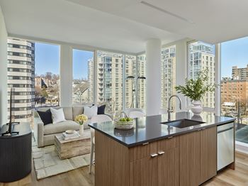 A modern kitchen with a view of the city.