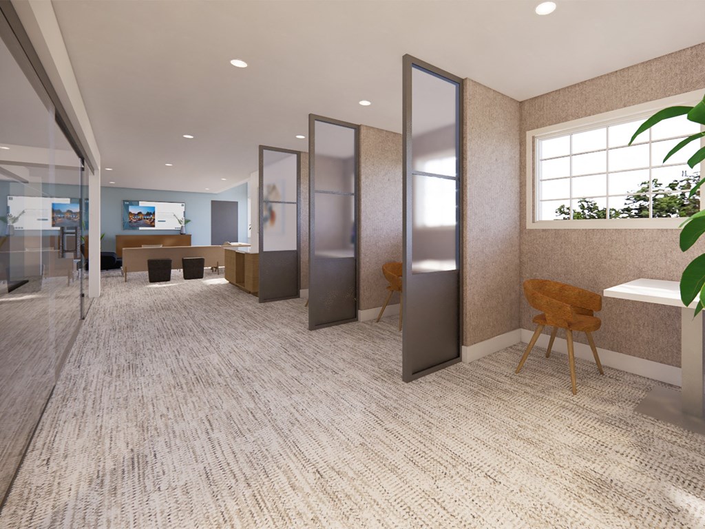 a lobby with a reception area and glass doors