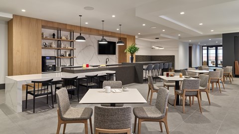 A modern dining area with wooden chairs and tables.