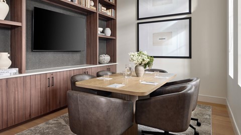 A modern dining room with a dark brown table and chairs.