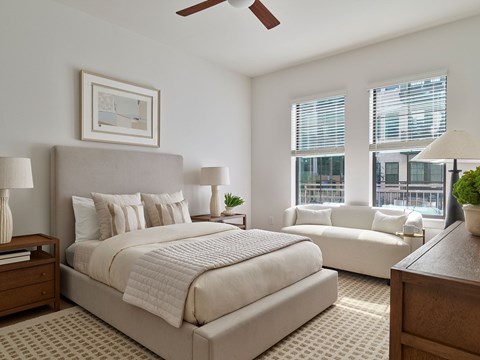 A bedroom with a large bed and a couch.