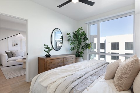 a bedroom with a large bed and a large window at AVE Santa Clara, Santa Clara, CA