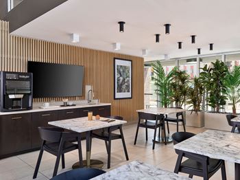 A modern kitchen with a dining table and chairs.
