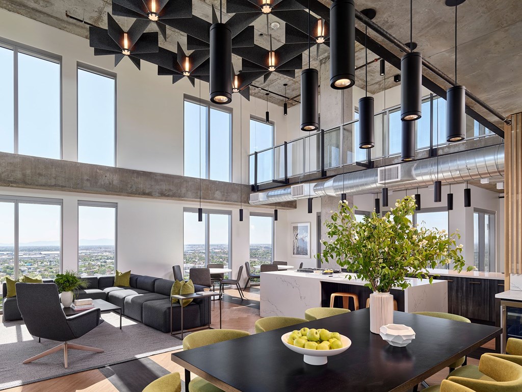 A modern dining room with a table set for two and a view of the city.