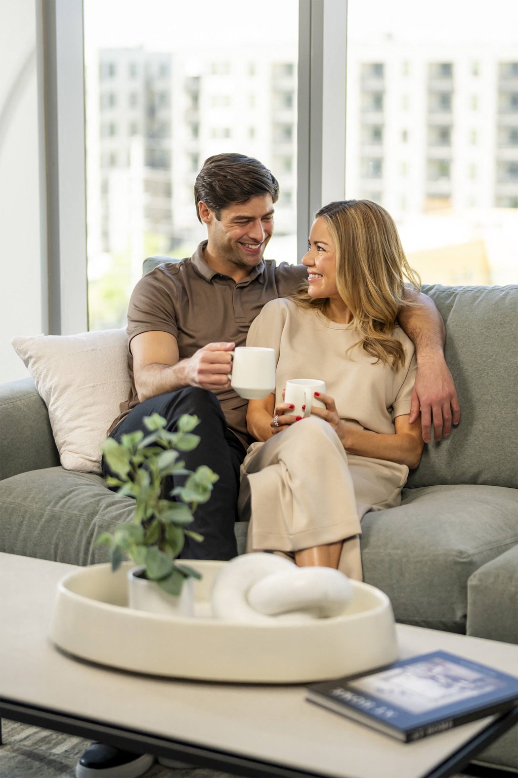 a man and woman sitting on a couch holding coffee cupsat AVE Phoenix Sky, Phoenix, AZ, Arizona , 85003