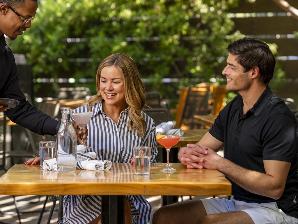 a man and woman sitting at a table with drinksat AVE Phoenix Sky, Phoenix, 85003