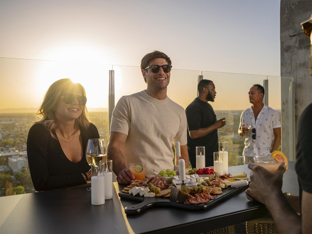 a group of people sitting at a table with a tray of food at AVE Phoenix Sky, Phoenix, Arizona