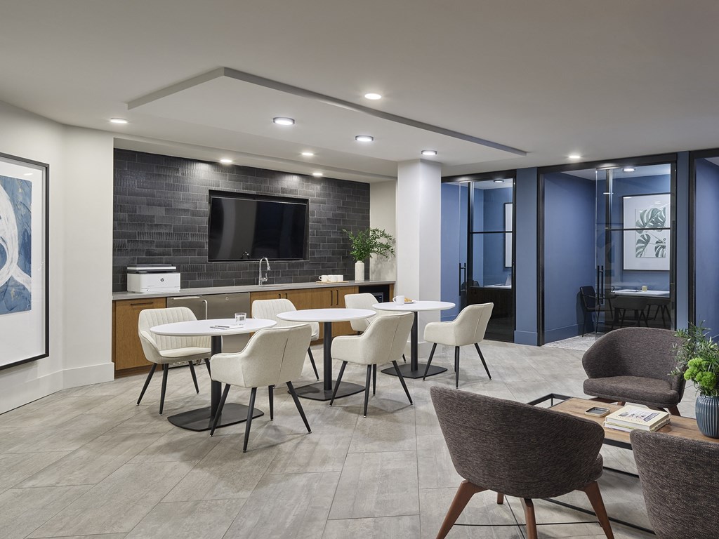 A modern kitchen with a dining table set up.