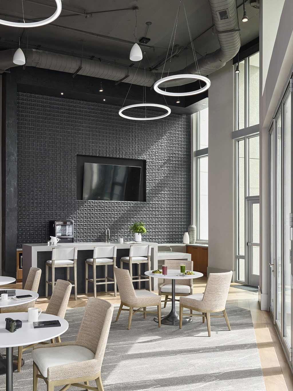 A modern dining room with a large table and chairs.