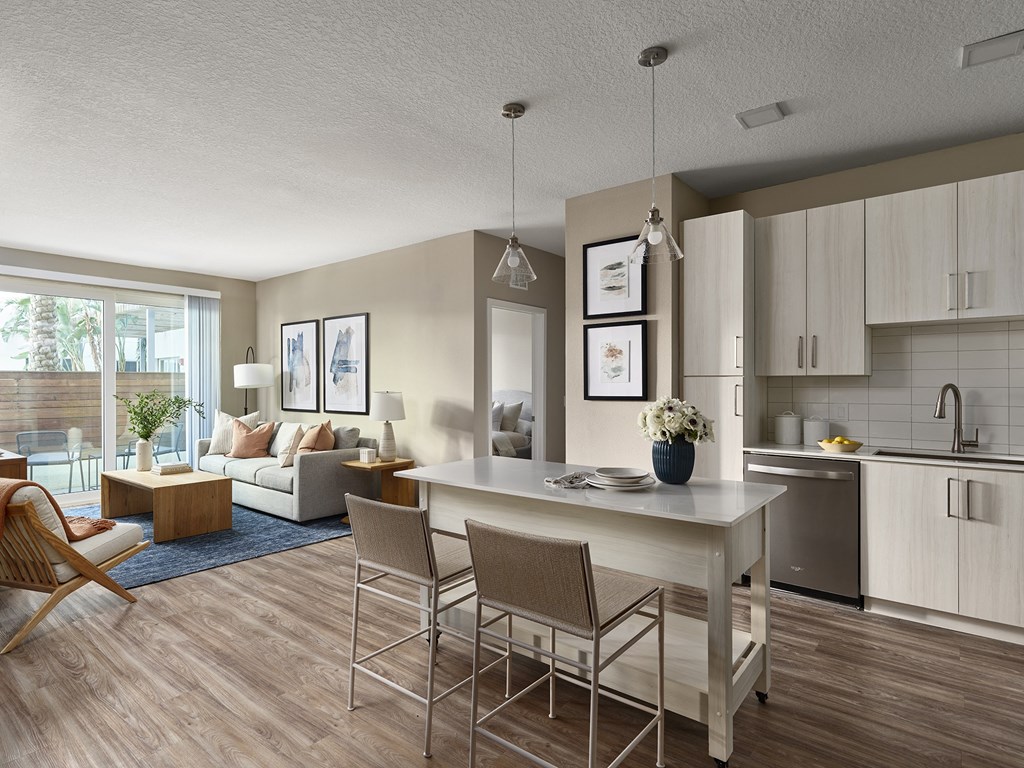 A modern kitchen with a dining table and chairs.