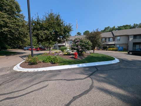 A roundabout with a red fire hydrant in the middle of it.