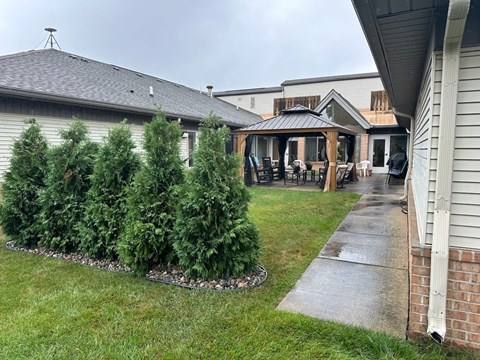 a backyard with a gazebo and a yard with trees