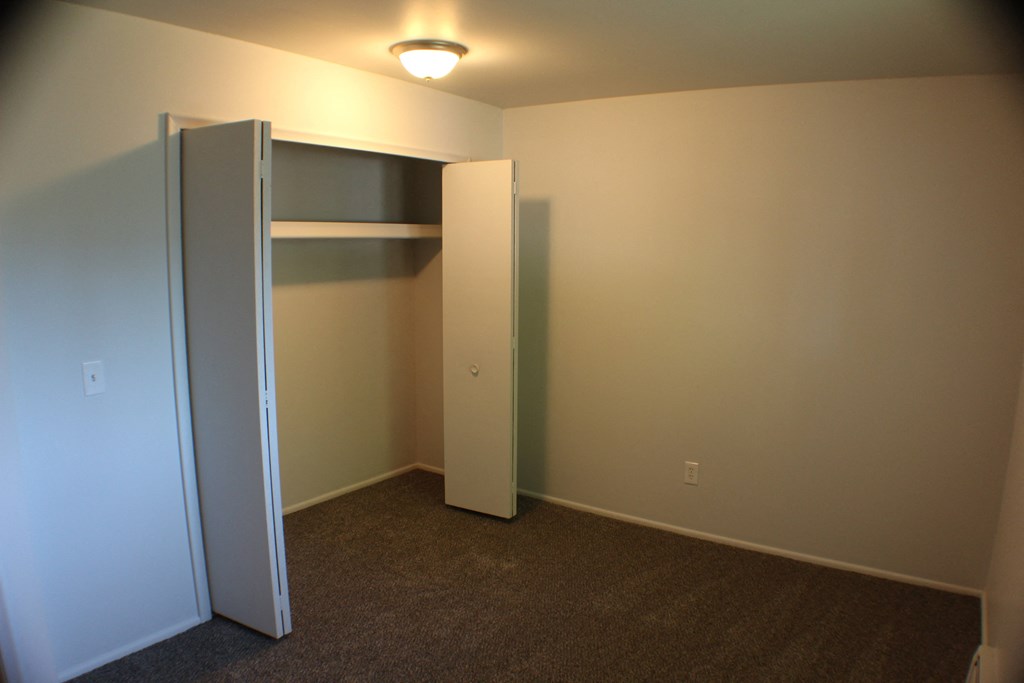 a room with a closet and a light on the ceiling
