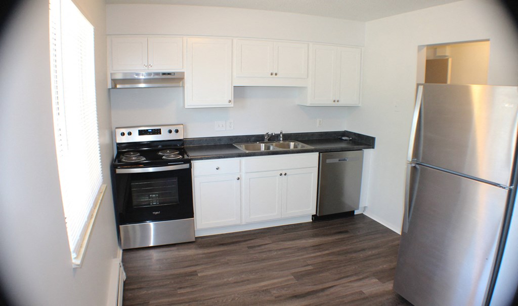 a kitchen with stainless steel appliances and white cabinets