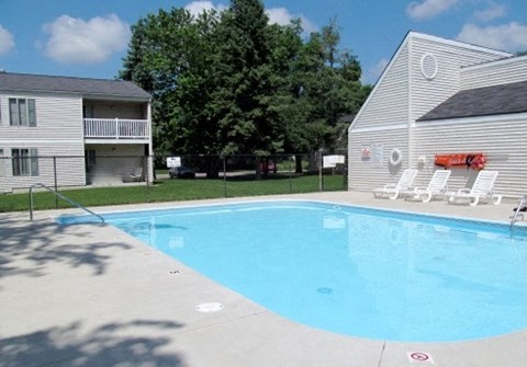 a large swimming pool in front of a house