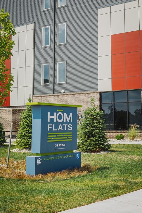 a home flats sign in front of a building