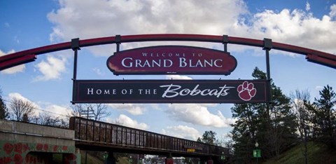a sign for the grand blanc home