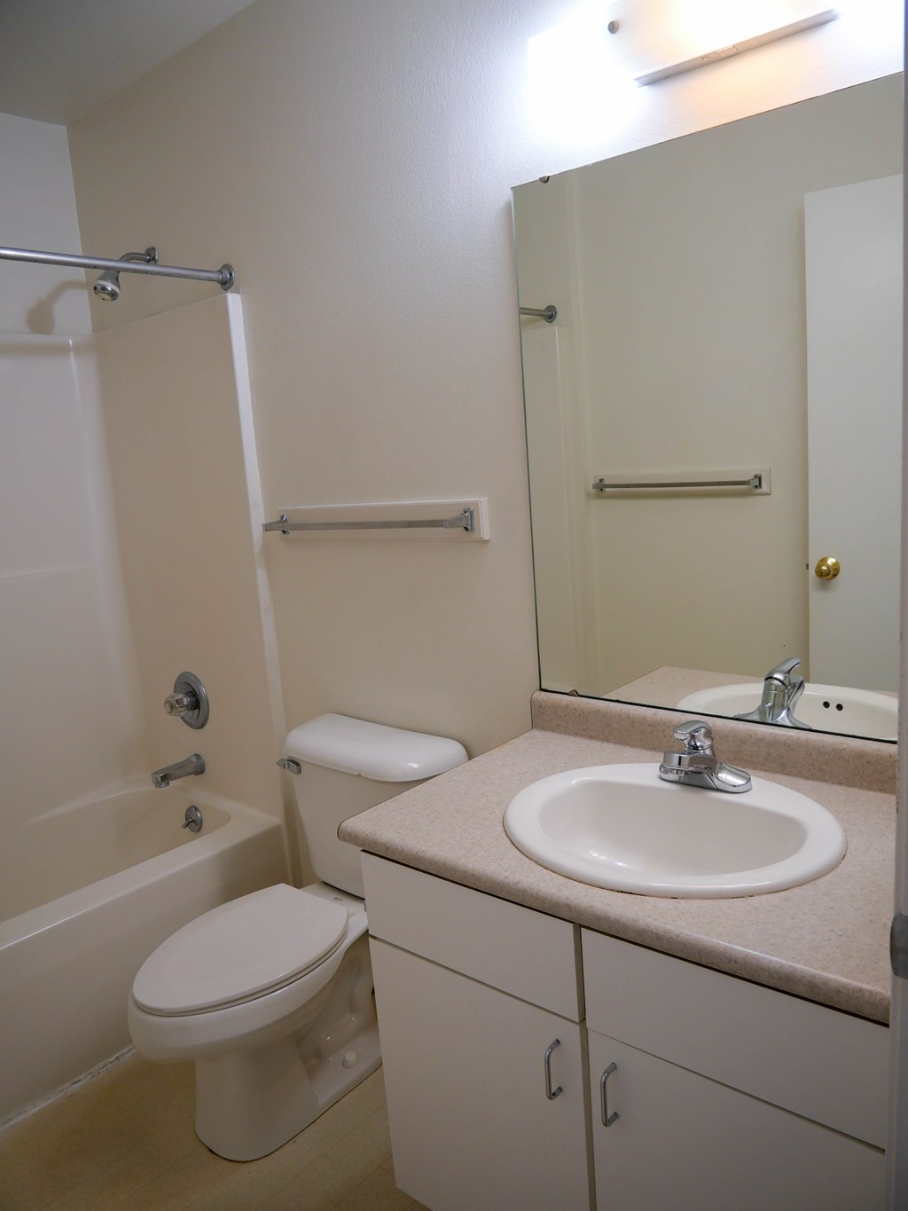 A white toilet sits next to a white sink in a bathroom.