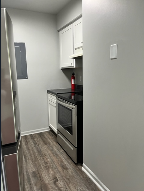 a small kitchen with a stove and a refrigerator