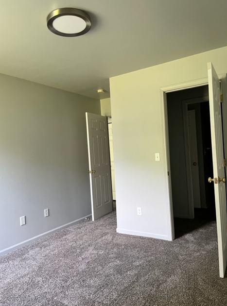 a room with a hallway and a door to a closet
