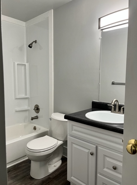 a white bathroom with a toilet and a sink