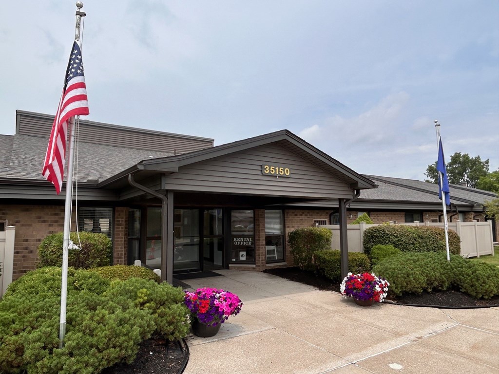 The front of a building with a grey roof and a sign that reads "35150" is shown.