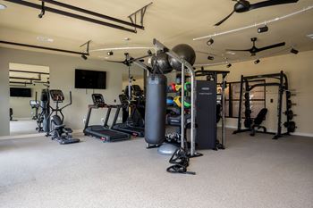 a gym with weights and other exercise equipment in a home at The Augustan, Georgia, 30901