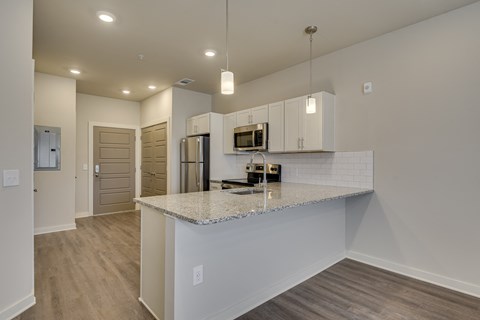 Kitchen peninsula with area for seating at The Augustan, Georgia, 30901