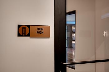 a door to a room with a zoom room sign on the wall at The Augustan, Augusta, Georgia