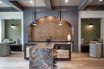 a reception area with a marble reception desk and two lamps at The Augustan, Georgia
