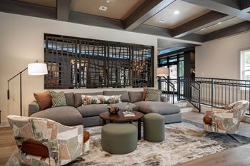 a living room with a couch and chairs and a wine cellar at The Augustan, Augusta, GA