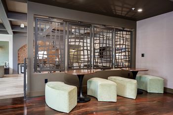 a room with a table and stools in front of a glass window at The Augustan, Georgia, 30901
