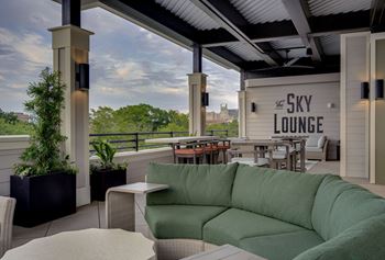 a patio with a green couch and a view of the sky lounge at The Augustan, Augusta, 30901
