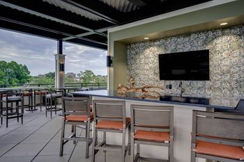 a bar and seating area with a television on the wall at The Augustan, Georgia