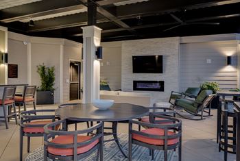 a living room with a table and chairs and a fireplace at The Augustan, Augusta