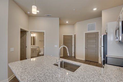 a kitchen with a sink and a large counter top at The Augustan, Augusta, 30901