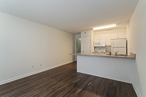 A kitchen area with white cabinets and a microwave.