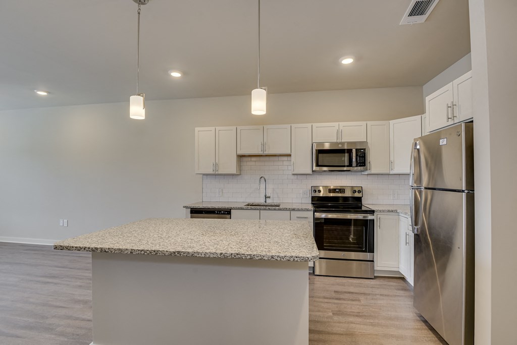 a kitchen with stainless steel appliances and a granite counter top
