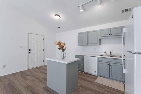 a white and gray kitchen with a refrigerator and a sink at Sterlington Apartments, Georgia, 30813